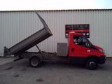 a red truck that is parked in front of a building
