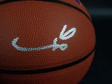 nike logo on a basketball on a black background