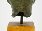 an image of a sculpture of a head on a wooden base