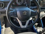 the interior of a small car with a steering wheel and dashboard