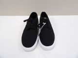 a pair of black and white sneakers on a white surface