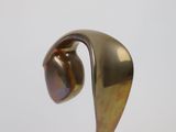 sculpture of a curved metal object on a white surface
