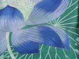 a close up of a blue flower on a green background