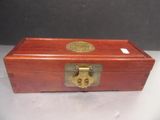 an old wooden box with a brass lock on top of it
