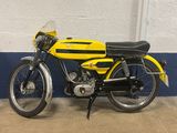 a yellow and black motorcycle parked in a garage