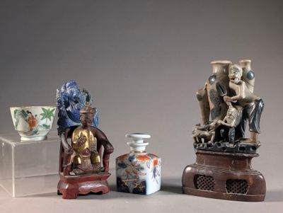 three asian figurines are sitting next to each other on a table