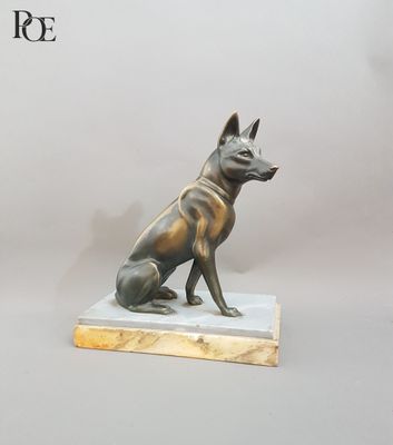 bronze statue of a dog sitting on a marble base