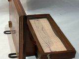 a wooden box with a piece of paper inside of it