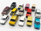 a lot of toy cars that are on a white surface