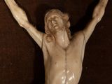 a statue of jesus on the cross with his hands up