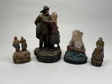 several figurines of a man and a woman on a boat