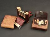 three small leather cases with cigarettes in them on a table