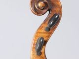 a close up of a violin on a stand with a white background