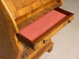 a wooden bench with a pink cushion in it