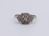 a close up of a diamond ring on a white surface