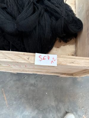 a pile of black wool in a wooden box