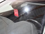 a sticker on the windshield of a car that is broken