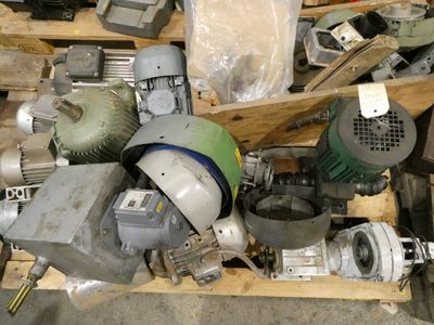 a pile of assorted machinery on a pallet in a warehouse