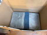a box with a mattress and a blanket inside of it
