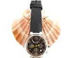 a watch that is sitting on top of a seashell