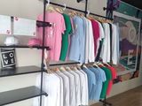 a rack of clothes on a wall in a store