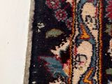 a cat that is laying on a rug on the floor