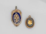 deux pendentifs en verre doré et bleu, l'un représentant un lion et l'autre un médaillon