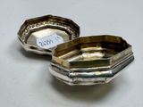 pair of silver plated ashtrays with engraved labels on them