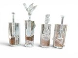 five glass vases with sand in them on a white surface