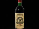 a bottle of red wine on a black background