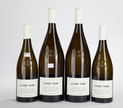 three bottles of wine sitting next to each other on a table