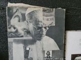an old black and white photo of a man with a hat and glasses