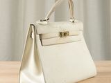 a white purse sitting on top of a wooden table