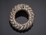 a silver ring with a braided design on it