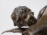 a statue of a boy holding a bird in his hand
