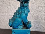 blue foo foo foo statue sitting on top of a blue box on a table