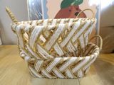 a basket that has a handle on it on a table