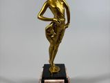 bronze statue of a woman holding a ball on a marble base