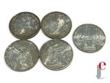 six coins are shown on a white surface with a red and white logo