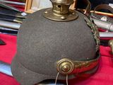 a helmet and a sword on a red table