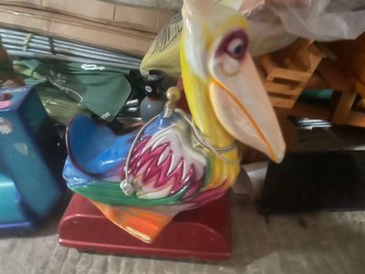 a plastic bird that is sitting on top of a table