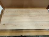 a wooden box with holes in it on a table