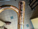 a close up of a brass instrument on a tiled floor