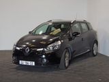 the small black car is parked in a room with a checkered floor