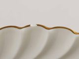 an image of a white and gold plate with a gold rim