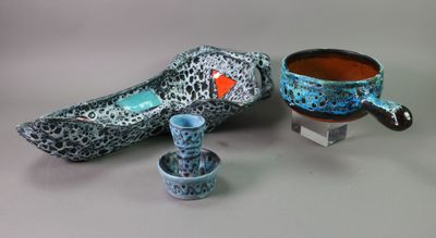 two cups and a bowl sitting next to each other on a table