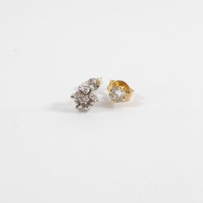 a pair of diamond stud earrings on a white background