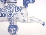 a ceramic figurine of a camel with a rider on its back