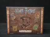 the harry potter board game is sitting on a black surface