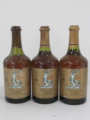 three bottles of wine sitting next to each other on a white surface